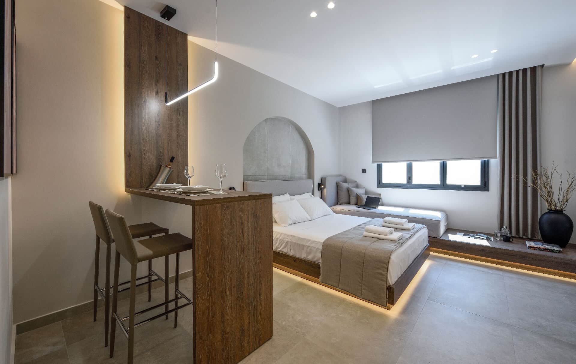 The suite from the bar corner: the queen-size bed, the daybed by the window and the table