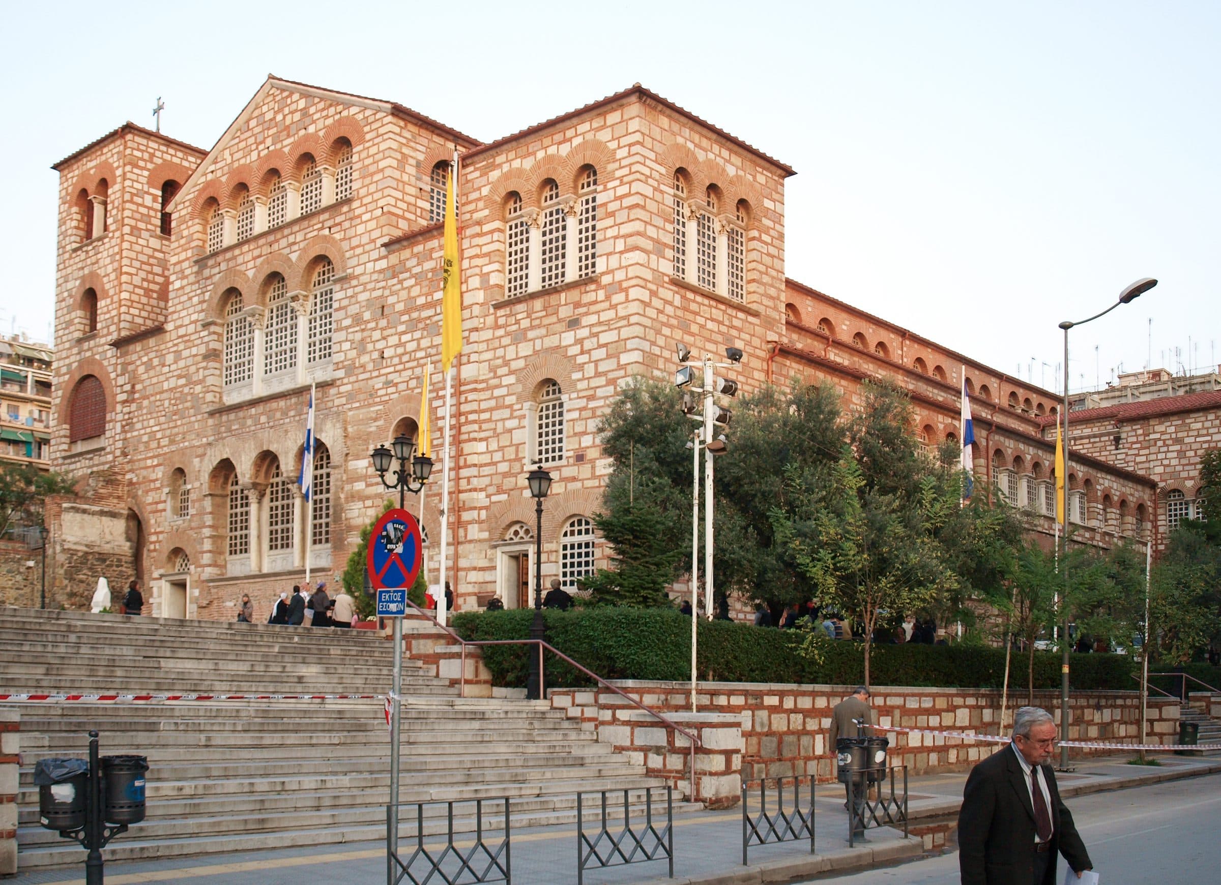The basilica of Agios Dimitrios from the street, its arcaded windows and flags